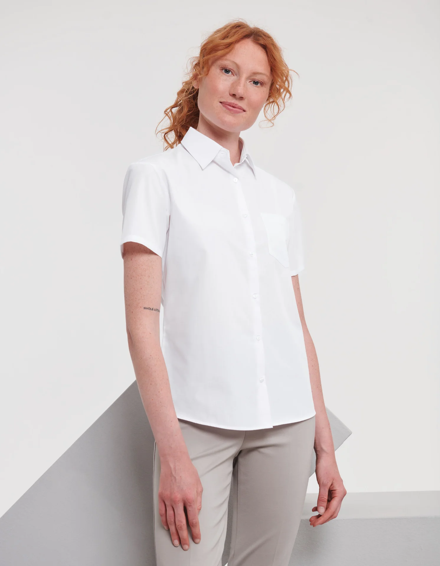 russell-r935f-ladies-short-sleeve-poly-cotton-easy-care-poplin-shirt-white-model-1 Russell Ladies Short Sleeve Polycotton Easy Care Poplin Shirt
